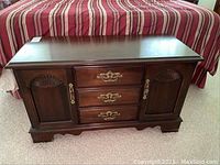 Front view of Lane cedar chest showing drawers, side cabinet doors with shell carvings, and brass handles.