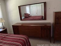Full view of walnut dresser with matching wall mirror hung above