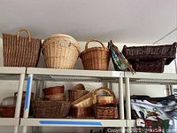Wide view of shelves displaying various woven baskets of assorted sizes and colors including small to medium sizes, rounded and rectangular shapes, some with handles.