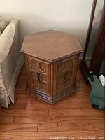 Full view of the vintage hexagonal commode style side table showing the overall shape, color, and top surface condition.