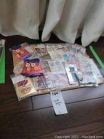 Top-down photo showing multiple vintage hockey and baseball cards, including sealed packs and promotional material spread on a table.