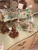 Chandelier and both sconces on dresser, overview of lot contents