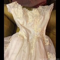 Close-up of vintage wedding dress bodice with floral lace applique and chiffon overlay