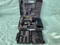Craftsman cordless drill driver open in carrying case with charger and battery, plus two Mastercraft bit sets open showing various drill and screwdriver bits.