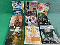 Overview of all nine hardcover interior design books laid out on a green surface, showing titles and cover art.