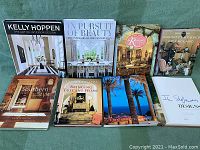 Photo of all eight hardcover books arranged on green fabric, showing titles and front covers.