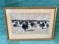Overall view of framed ink drawing showing entire composition of bison herd under glass.