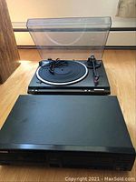 Photo shows Technics turntable with clear dust cover and Pioneer CD player with front controls.