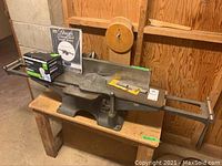Bench-top Beaver joint-planer mounted on wooden bench. Accessories include replacement blade pack and electrical component in box.