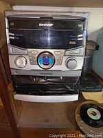 Sharp CD stereo system model CO-C2800 with some visible damage on lower speaker area.