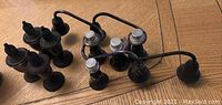 Four sterling silver salt and pepper shakers with weighted bases and multiple sterling silver candelabra pieces arranged on wooden table