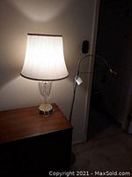 Floor lamp with focusing light in a living area corner, showing height and arm design.
