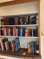 Three shelves filled with assorted hardcover reference books including medical, psychological, carpentry, and furniture titles.