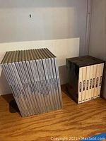 A group of 6 Time Life books from the Time Capsule 1939-1945 series with beige spines in a box on wooden surface.