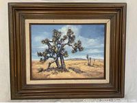 Full view of the framed oil painting showing a desert landscape with a large desert tree in the foreground, painted by Jo Gayle.