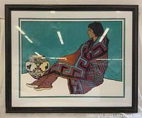 Framed silk screen artwork depicting a Native American woman with a colorful blanket and a pottery vase.