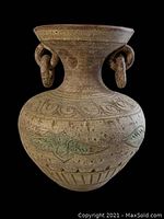 Front view of large terracotta planter with rings, showing carved and painted decorative patterns.