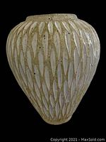 Front view of large cream-colored terracotta planter showing textured leaf-like pattern design over the surface.