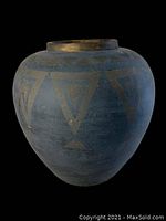 Front angle view of large blue terracotta planter with gold geometric triangles around upper body, showing shape and paint detail