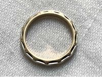 Top-down view of 14K yellow and white gold wedding band showing overall design and texture.