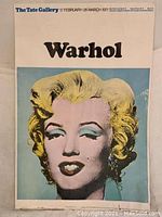 Full front of poster showing Marilyn Monroe portrait, “Warhol” text and exhibition dates