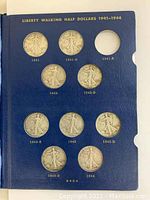 First interior page of album showing coins dated 1941–1944 with one empty slot.