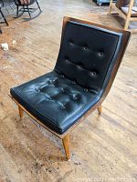 Front-angle view of chair showing overall shape, upholstery and frame