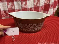 Photo of Pyrex Cinderella casserole bowl showing front floral Woodland pattern and spout handle.