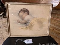 Framed vintage infant print showing full piece and original frame, label tag present.