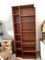 Full frontal view of the wooden bookshelf showing its shelves and dimensions.