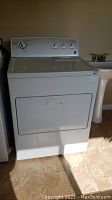 Full view of Kenmore Series 500 white clothes dryer showing front door and control panel area.