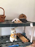 Image showing various kitchen and decorative items including bunny cookie jar, rolling pin, baskets, and small decorative wooden box.
