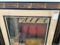 Abstract wall art with visible textures, layered shapes, and warm muted colors in a distressed frame.