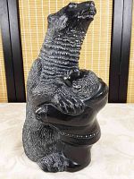 Front view showing bear standing upright embracing human figure