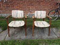 Both chairs front view against brick wall