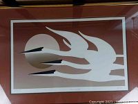 Framed art print showing three white cranes flying with a circular sun/moon in the background, in brown gradient tones.