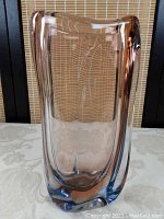 Front view of rectangular art glass vase showing salmon and blue coloration with clear glass body.