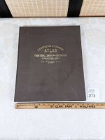 Cover front board of black cloth hardcover atlas with gold embossed title.