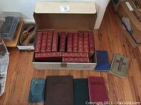 Box of red leather-spine Shakespeare volumes (approx. 14) plus four additional hardcovers displayed front