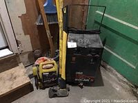 Original photo showing both the Solar 360 battery charger and Prestone Portable Power Jump It set on a concrete floor near a green door and wooden platform.