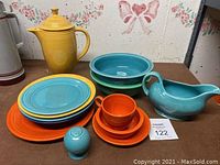 Overview of the complete set showing dinnerware and serving bowls in multiple colors