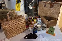 Photo showing the collection of vintage spice containers, a woven purse, napkin holder, and several small items on a table