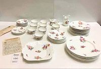 Full view of the 41 pieces including plates, cups, saucers, serving platter, creamer pitcher, sugar bowl, and provenance letter