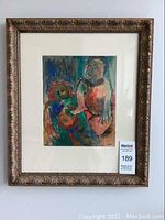 Front view of framed painting showing abstract figures in vibrant colors, signed lower right.