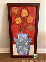 Frontal view of the framed encaustic wax floral painting showing entire artwork with yellow flowers in blue vase on red background.