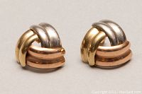 Front view of the 10kt tri-coloured gold earrings showing the intertwined design with white, yellow, and rose gold bands.