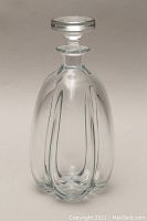 Front view of the clear glass Scandinavian decanter with stopper, showing elongated curved design and smooth glass.