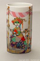 Front side of porcelain bud vase showing colorful Commedia Dell Arte character with peacock feathers, detailed with pink and gold tent poles and garlands.