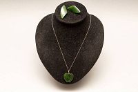 Full jewelry set displayed on black bust showing necklace with jade pendant and matching earrings.