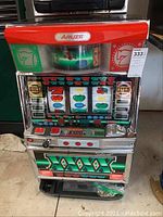 Front view of the Aruze slot machine showing control panel, reels, and coin tray